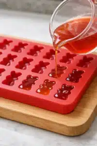 Homemade Gummy Bears with Fruit Juice (Quick & Chewy) 5 homemade gummy bears Filling gummy bear molds with mixture