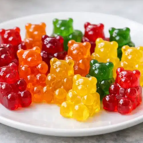 Homemade Gummy Bears with Fruit Juice (Quick & Chewy) 3 Homemade gummy bears on a white plate